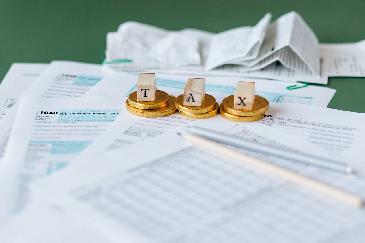 home-services-03 Close-up of tax forms, receipts, and coins symbolizing financial accounting and taxes.